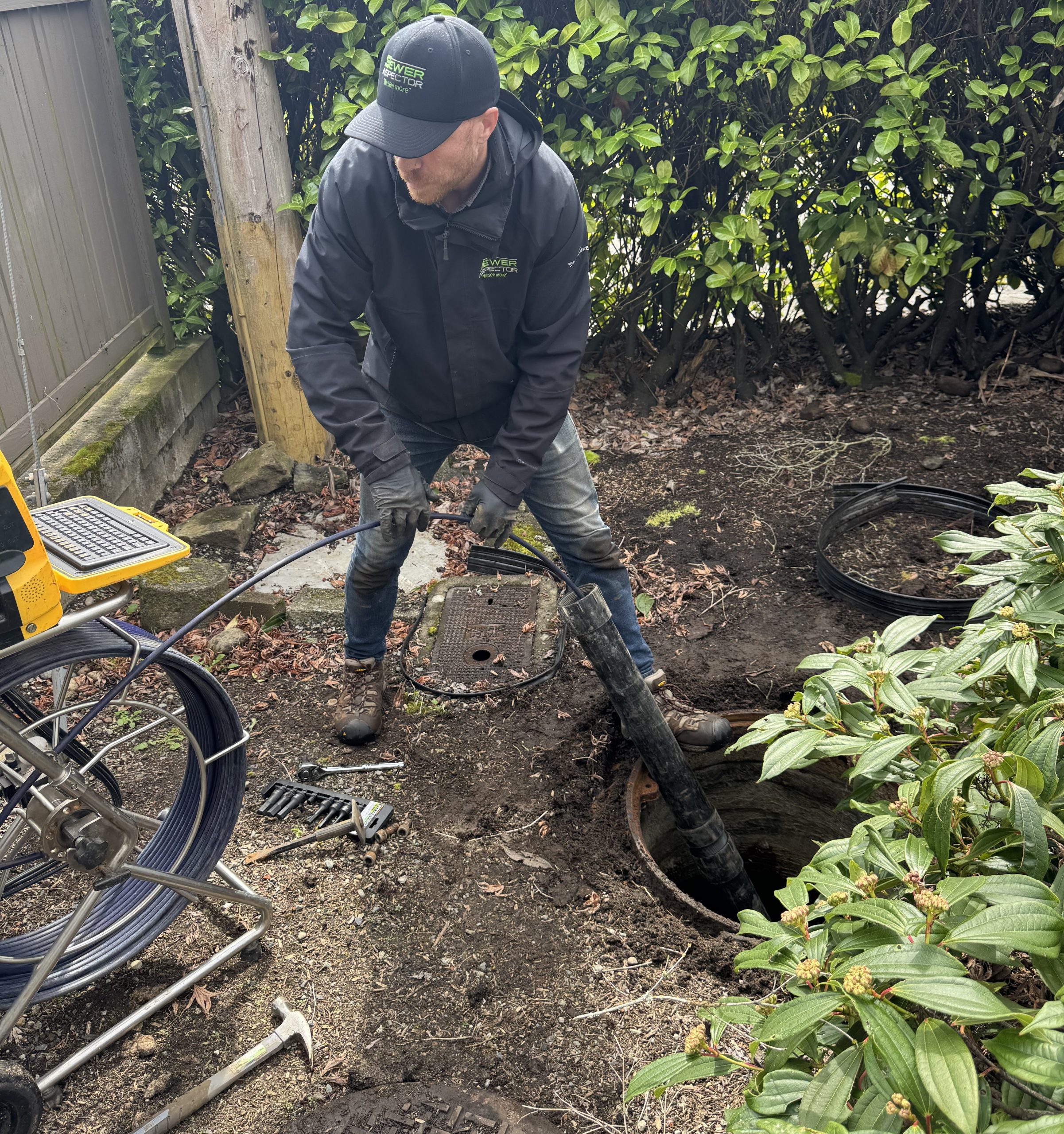 Sewer Inspector scopes a sewer line from an exterior clean out